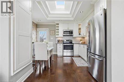 BRIGHT, open plan kitchen, living room with oversized picture window! You'll love entertaining in this meticulously maintained home. - 208 East 44Th Street, Hamilton, ON - Indoor Photo Showing Kitchen