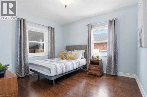 Full bathroom on main floor is GORGEOUS with neutral decor! Features generous vanity with elegant wall mounted fixtures, shower and tub combo. - 208 East 44Th Street, Hamilton, ON - Indoor Photo Showing Bedroom