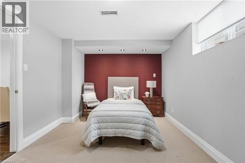 Lower level bedroom features cozy carpet and decorative accent wall. Walk-in closet is massive & a dream! - 208 East 44Th Street, Hamilton, ON - Indoor Photo Showing Bedroom
