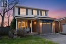 Welcoming front entry featuring brick, siding, and an inviting covered front porch - 3200 Greenbough Crescent, Burlington, ON  - Outdoor With Deck Patio Veranda 