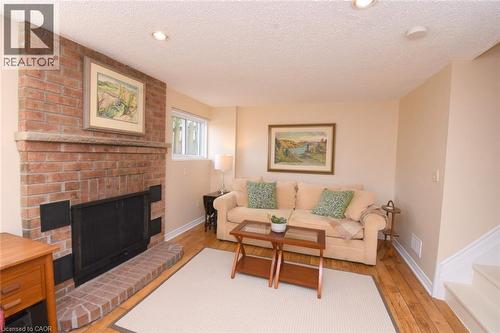 Family room featuring wett-certified wood-burning fireplace - 3200 Greenbough Crescent, Burlington, ON - Indoor Photo Showing Living Room With Fireplace