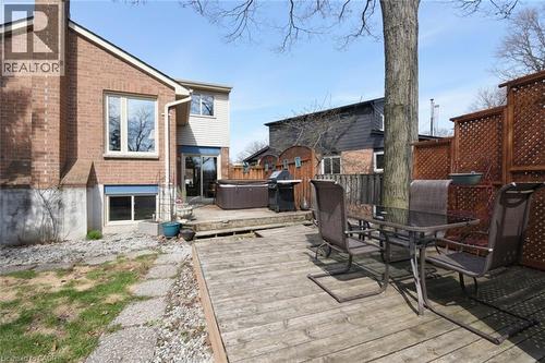 Private deck featuring outdoor dining space, area for grilling, and a hot tub - 3200 Greenbough Crescent, Burlington, ON - Outdoor With Deck Patio Veranda