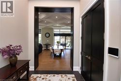 Corridor featuring coffered ceiling, recessed lighting, and dark tile patterned flooring - 