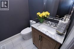 Bathroom featuring vanity and light tile patterned flooring - 