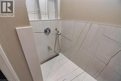 Bathroom featuring a tile shower - 