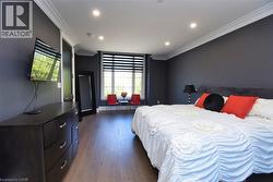 Bedroom with ornamental molding, dark wood-style flooring, and recessed lighting - 