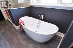 Full bath with a marble finish shower and a freestanding tub - 