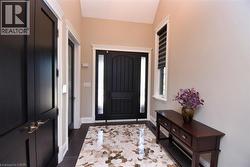 Entryway with dark tile patterned flooring and baseboards - 