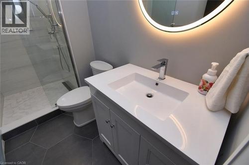 Full bath with vanity, a tile shower, and dark tile patterned floors - 68 Mountain Brow Boulevard, Hamilton, ON - Indoor Photo Showing Bathroom