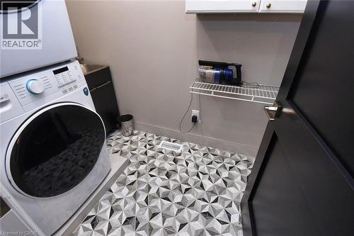 Laundry room with baseboards and stacked washing machine and dryer - 68 Mountain Brow Boulevard, Hamilton, ON - Indoor Photo Showing Laundry Room