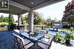 View of patio with outdoor dining area and an outbuilding - 