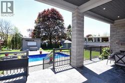View of swimming pool with patio surround and an outdoor structure - 