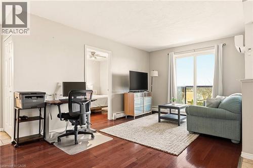 Living area with medium vinyl wood-style floors, an office area, sliding balcony doors to balcony - 2373 E King Street E Unit# 45, Hamilton, ON - Indoor
