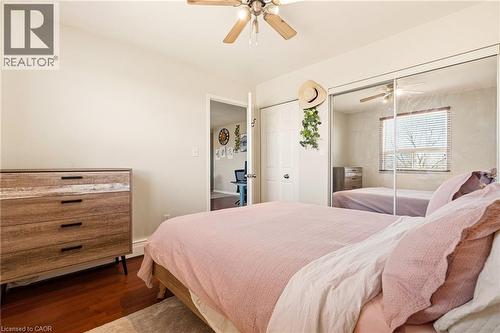 Bedroom with medium vinyl wood flooring, a closet, and a ceiling fan - 2373 E King Street E Unit# 45, Hamilton, ON - Indoor Photo Showing Bedroom
