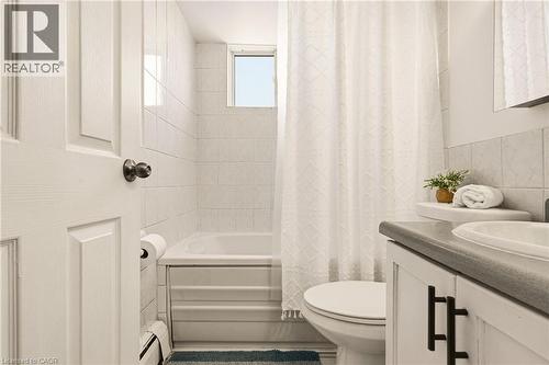 Bathroom with vanity, shower / bath combo with shower curtain, tile walls - 2373 E King Street E Unit# 45, Hamilton, ON - Indoor Photo Showing Bathroom