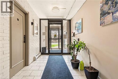 Entryway with brick wall and light tile patterned floors - 2373 E King Street E Unit# 45, Hamilton, ON - Indoor Photo Showing Other Room