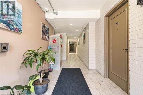 Corridor with brick wall, light tile patterned floors, and recessed lighting - 2373 E King Street E Unit# 45, Hamilton, ON - Indoor Photo Showing Other Room