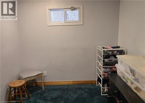 Miscellaneous room featuring dark carpet and baseboards - 67 Pinemeadow Crescent, Waterloo, ON - Indoor Photo Showing Other Room