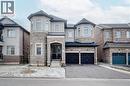 View of front of property with stone siding, asphalt driveway, a balcony, and a garage - 150 Goodwin Crescent Unit# Bsmt, Milton, ON  - Outdoor With Facade 