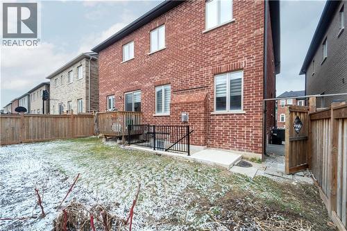 Back of property featuring brick siding and a fenced backyard - 150 Goodwin Crescent Unit# Bsmt, Milton, ON - Outdoor With Exterior