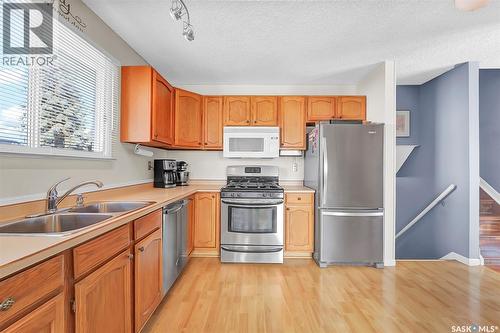 703 Candle Court, Saskatoon, SK - Indoor Photo Showing Kitchen With Double Sink