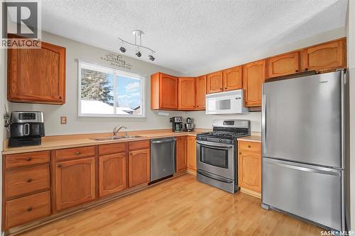 703 Candle Court, Saskatoon, SK - Indoor Photo Showing Kitchen With Double Sink