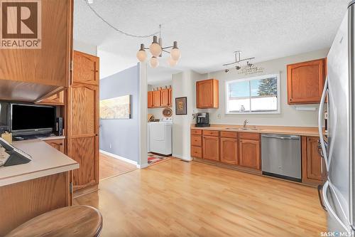 703 Candle Court, Saskatoon, SK - Indoor Photo Showing Kitchen With Double Sink