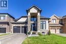 View of front of house featuring stone siding, driveway, a front yard, and stucco siding - 72 Pond View Gate, Waterdown, ON  - Outdoor With Facade 
