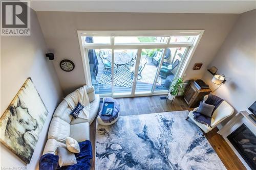 Living room featuring dark wood finished floors - 72 Pond View Gate, Waterdown, ON - Indoor With Fireplace