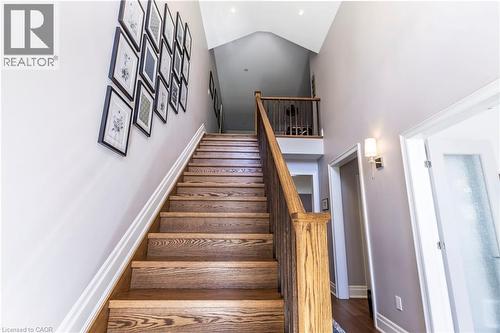 Stairway featuring a high ceiling and wood finished floors - 72 Pond View Gate, Waterdown, ON - Indoor Photo Showing Other Room