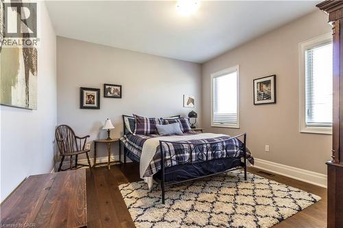 Bedroom featuring dark wood-style flooring and baseboards - 72 Pond View Gate, Waterdown, ON - Indoor Photo Showing Bedroom