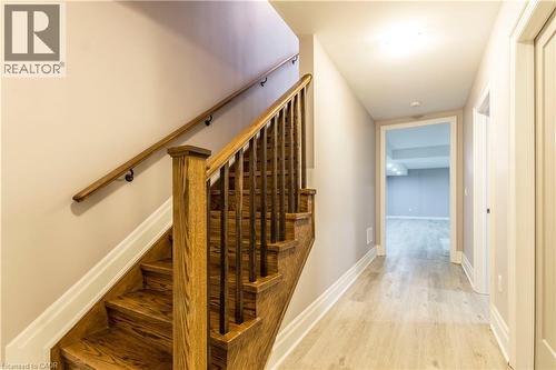 Stairway featuring wood finished floors and baseboards - 72 Pond View Gate, Waterdown, ON - Indoor Photo Showing Other Room