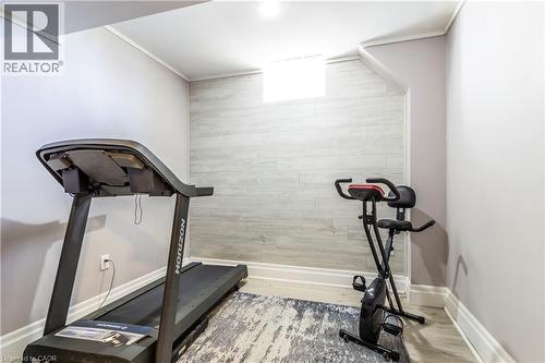 Exercise area featuring wood finished floors and baseboards - 72 Pond View Gate, Waterdown, ON - Indoor Photo Showing Gym Room