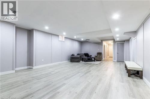 Living area with a decorative wall, light wood finished floors, and recessed lighting - 72 Pond View Gate, Waterdown, ON - Indoor Photo Showing Other Room