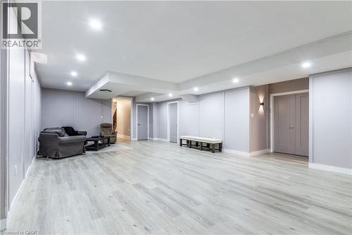 Finished basement with light wood finished floors and recessed lighting - 72 Pond View Gate, Waterdown, ON - Indoor