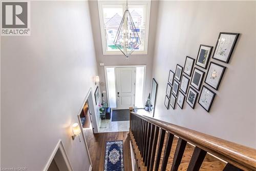 Foyer entrance with a high ceiling, hanging lights, and dark wood finished floors - 72 Pond View Gate, Waterdown, ON - Indoor Photo Showing Other Room
