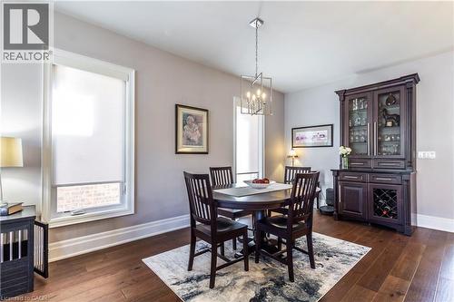Dining room with dark wood-style floors and hanging lights - 72 Pond View Gate, Waterdown, ON - Indoor Photo Showing Dining Room