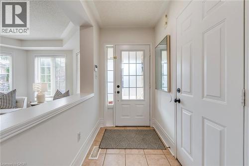 Doorway to outside featuring a textured ceiling and tile patterned floors - 5811 Page Crescent, Burlington, ON - Indoor Photo Showing Other Room