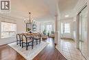 Dining space with wood-type flooring, a textured ceiling, a chandelier, and ornate columns - 5811 Page Crescent, Burlington, ON  - Indoor 