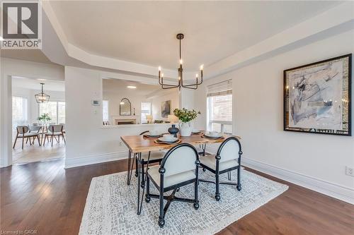 Dining space featuring suspended lighting and dark wood-style flooring - 5811 Page Crescent, Burlington, ON - Indoor Photo Showing Dining Room