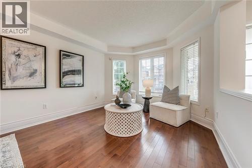 Living area featuring hardwood / wood-style flooring, healthy amount of natural light, and a raised ceiling - 5811 Page Crescent, Burlington, ON - Indoor