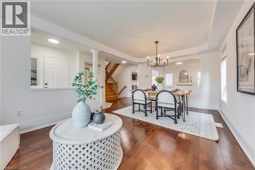Dining room featuring dark wood-style floors and hanging lights - 5811 Page Crescent, Burlington, ON - Indoor