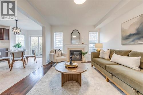 Living area with a fireplace with flush hearth and light wood-style flooring - 5811 Page Crescent, Burlington, ON - Indoor Photo Showing Living Room With Fireplace