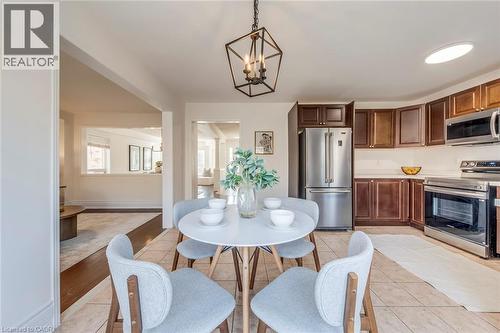 Dining room featuring suspended lighting and light tile patterned flooring - 5811 Page Crescent, Burlington, ON - Indoor