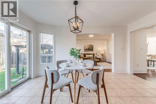 Dining space with suspended lighting and light tile patterned floors - 5811 Page Crescent, Burlington, ON - Indoor Photo Showing Dining Room