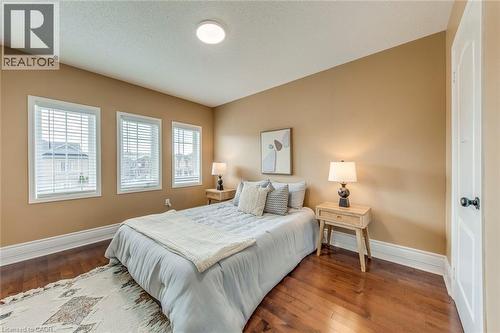 Bedroom featuring hardwood / wood-style flooring and a textured ceiling - 5811 Page Crescent, Burlington, ON - Indoor Photo Showing Bedroom