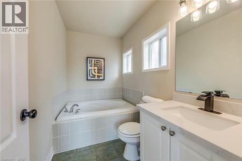 Bathroom featuring vanity, a garden tub, and dark tile patterned floors - 5811 Page Crescent, Burlington, ON - Indoor Photo Showing Bathroom