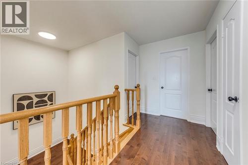 Hallway with dark wood finished floors and an upstairs landing - 5811 Page Crescent, Burlington, ON - Indoor Photo Showing Other Room