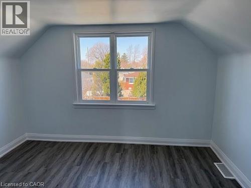 Bonus room with lofted ceiling and dark wood-style flooring - 322 Upper Gage Avenue, Hamilton, ON - Indoor Photo Showing Other Room