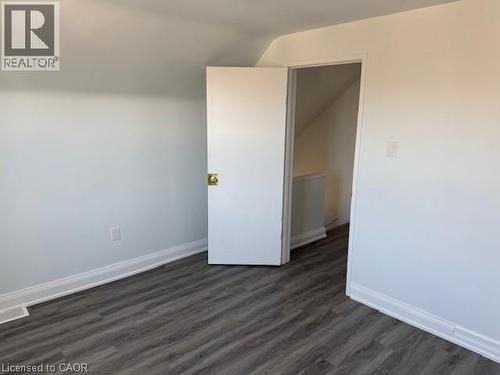 Unfurnished room featuring vaulted ceiling and dark wood-style floors - 322 Upper Gage Avenue, Hamilton, ON - Indoor Photo Showing Other Room